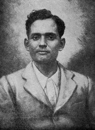Studio portrait of Jatindra Nath Das as a young man in a light jacket and open-collared shirt, looking towards the camera.